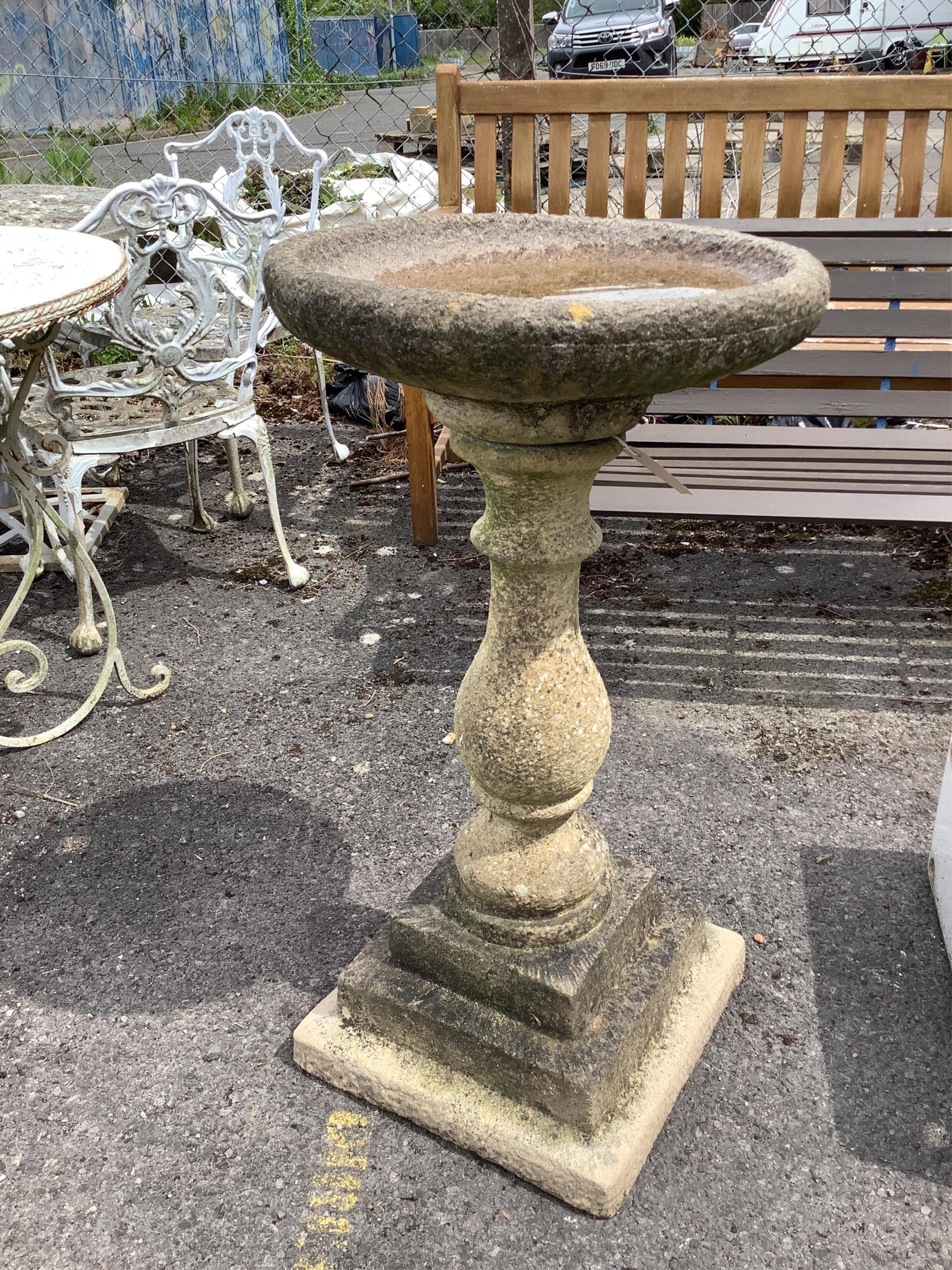 A reconstituted stone bird bath on baluster pillar, diameter 46cm, height 89cm